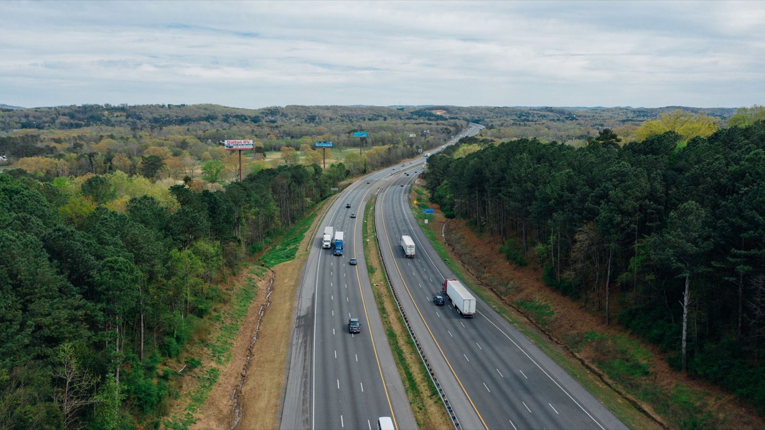 Major road upgrade: aerial view of a dual-carriageway highway through green countryside